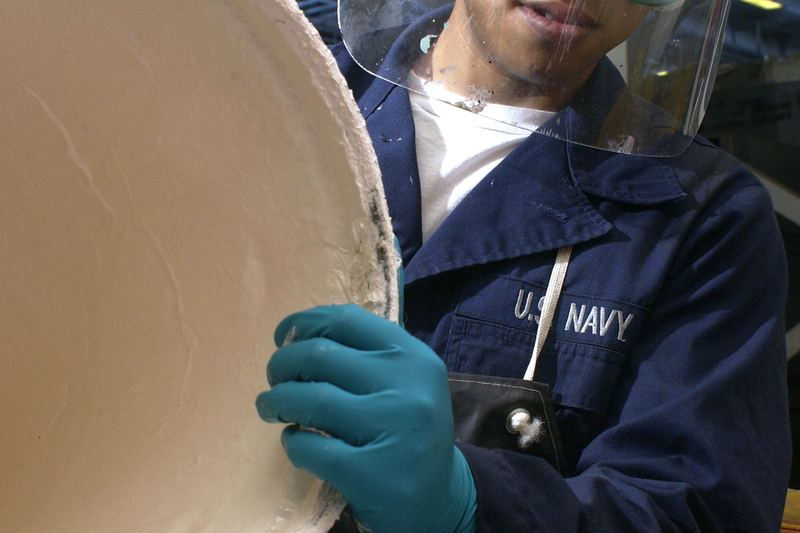 Worker in PPE preparing hazardous-material disposal